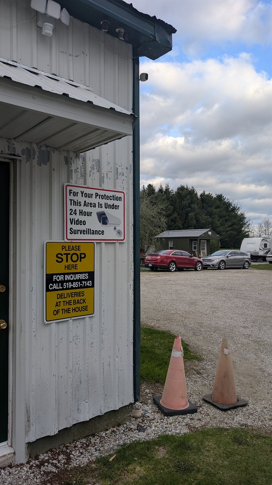 24-hour video surveillance signage at the Moro Storage entrance with the inquiries phone number 519-851-7143